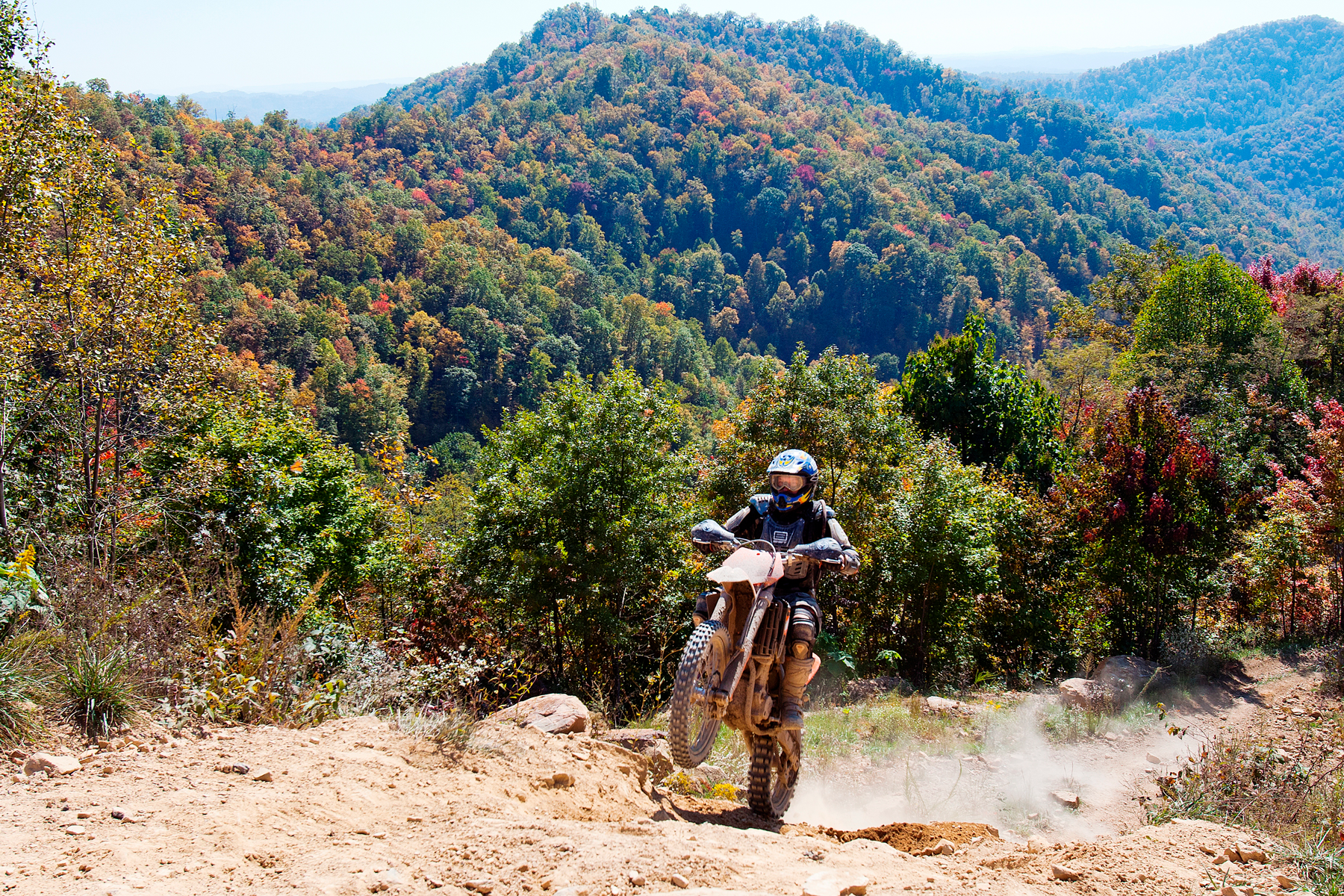 Hatfield McCoy mountain vista with dirt biker doing a wheelie uphill